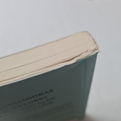 Livro azul claro com canto da capa duro danificado