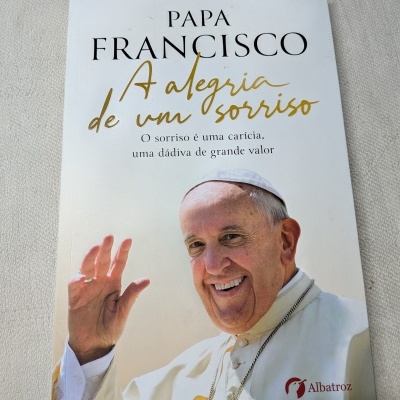 Capa do livro Papa Francisco com fotografia do Papa sorrindo e acenando, título e texto em várias fontes.