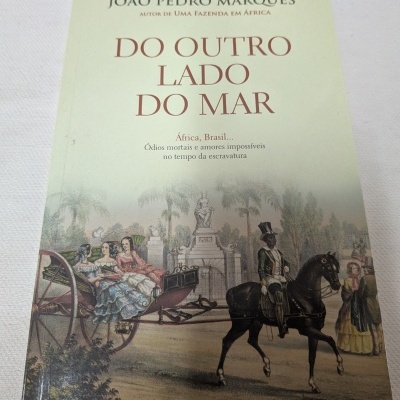 Capa de livro DO OUTRO LADO DO MAR com ilustração histórica de carruagem, cavalo e pessoas, texto em português.