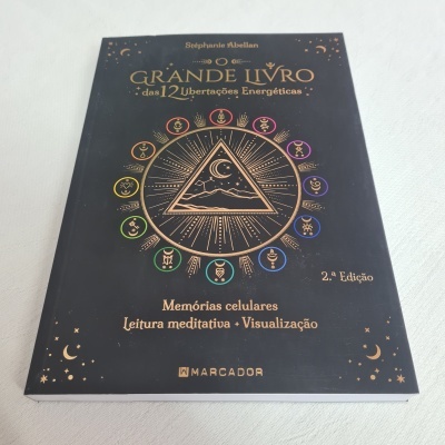 Capa de livro preto com texto dourado e colorido sobre libertações energéticas