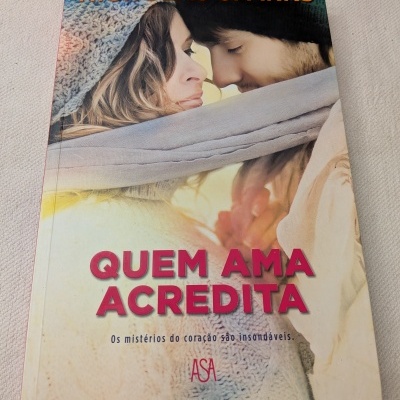 Capa de livro com casal e texto QUEM AMA ACREDITA de Nicholas Sparks.