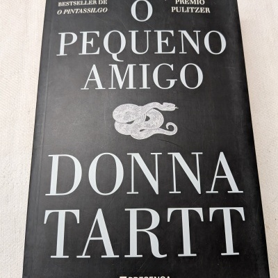 Capa de livro preto com texto branco e ilustração de cobra.