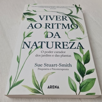 Livro 'VIVER AO RITMO DA NATUREZA' com folhas verdes na capa