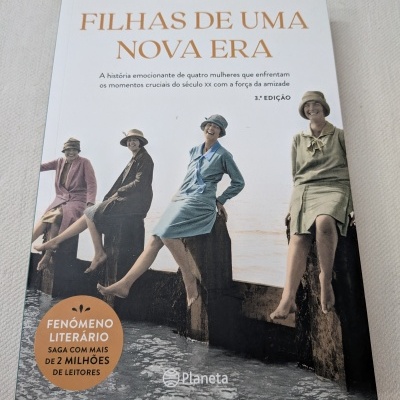 Capa do livro Filhas de uma Nova Era de Carmen Korn com quatro mulheres vintage sentadas junto à água