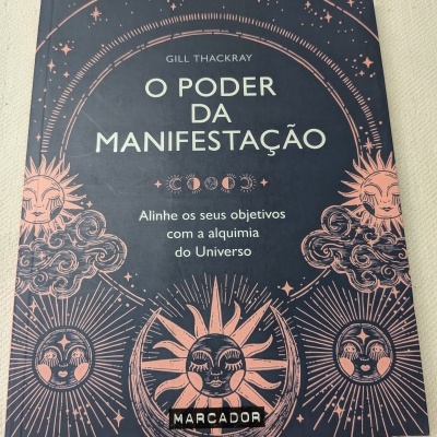 Capa de livro azul escura com ilustrações solares e lunares cor rosa e texto título em branco.