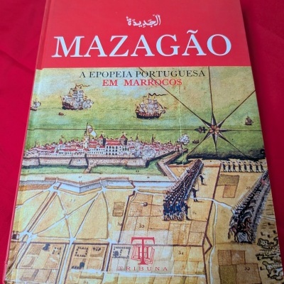 Capa de livro vermelho com ilustração histórica e texto MAZAGÃO, A EPOPEIA PORTUGUESA EM MARROCOS