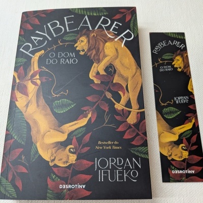 Capa de livro e marcador da colecção Raybearer com leão e leoa em fundo preto