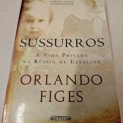 Livro Sussurros de Orlando Figes com capa amarela e imagem desbotada