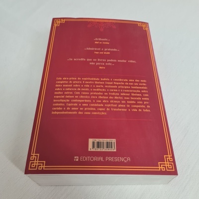 Livro com capa vermelha escura e texto amarelo e branco na contracapa