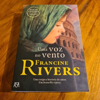 Capa do livro Uma Voz no Vento de Francine Rivers com imagem de mulher e Coliseu