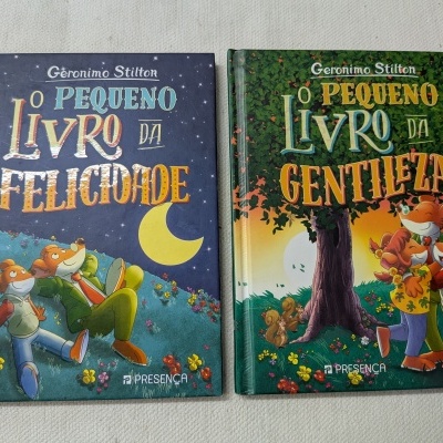 Dois livros de capa dura infantis de Geronimo Stilton, títulos em letras coloridas, com ilustrações de ratos em ambientes naturais.
