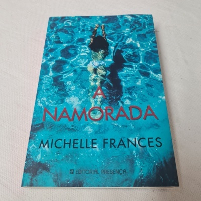Capa do livro 'A NAMORADA' com imagem de mulher nadando numa piscina azul