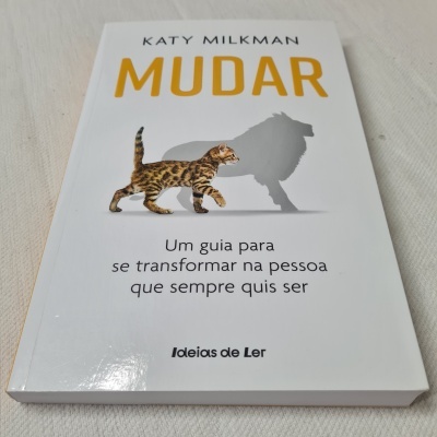 Livro MUDAR com imagem de gato e sombra de leão na capa