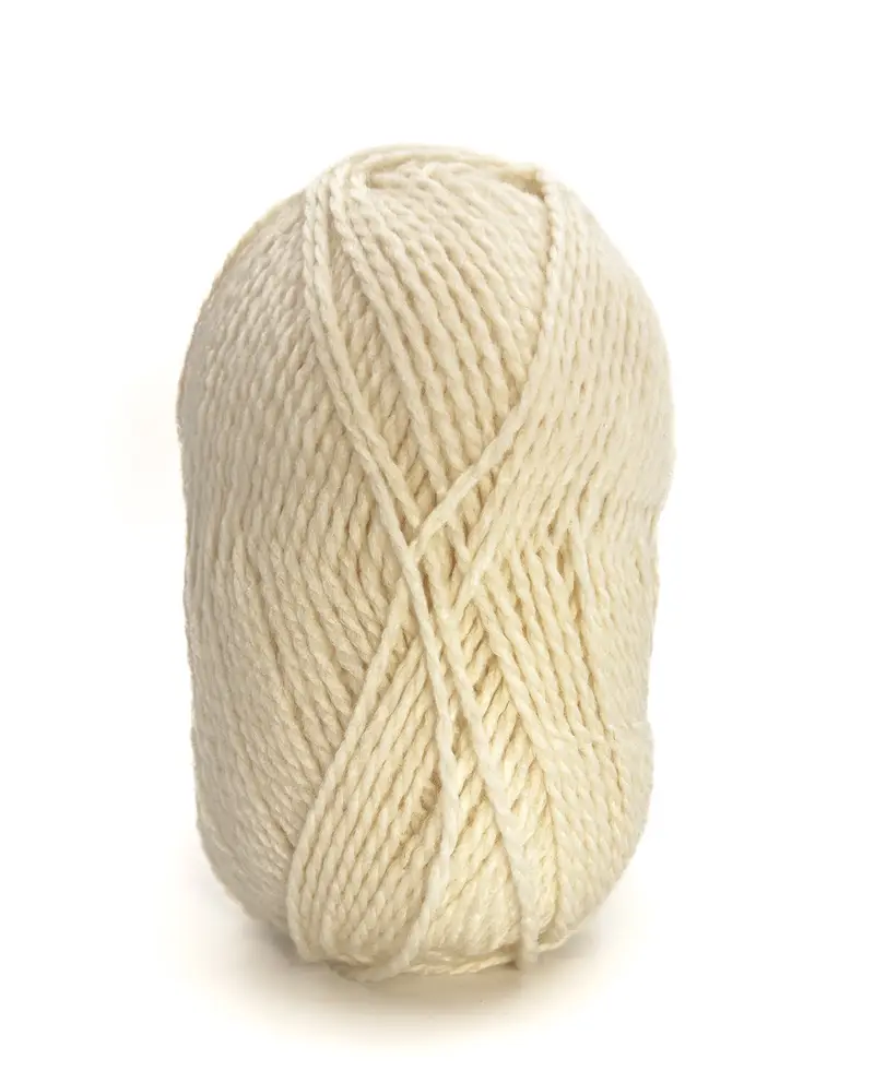Novelo de lã grosso creme sobre fundo branco