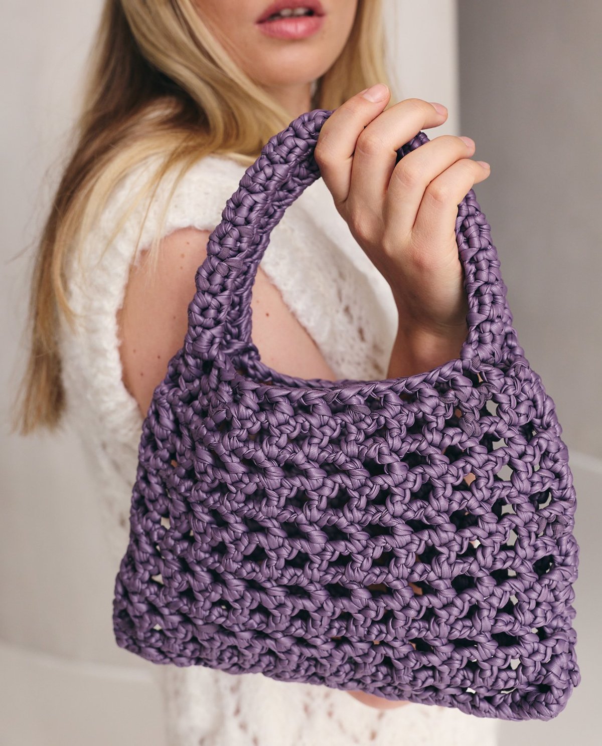 Mala feminina roxa em tricot com padrão de malhas e alça grossa
