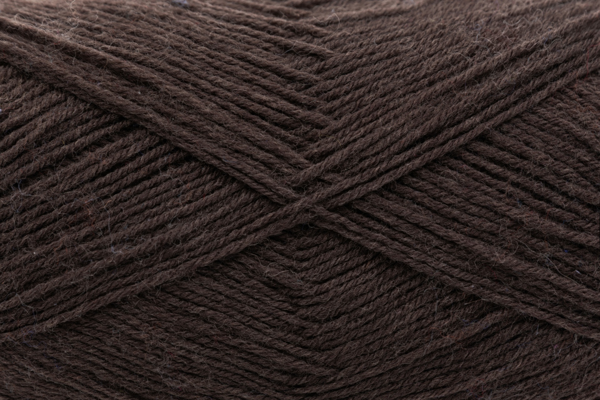 Novelo de lã castanha escura com fios entrelaçados em vista aproximada