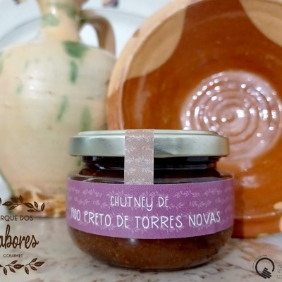 Frasco de chutney de figo preto com jarro e prato cerâmico ao fundo