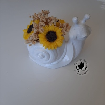 Vaso cerâmica branca forma caracol com flores amarelas e secas