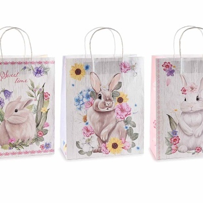 Três sacos de papel decorados com coelhos e flores coloridas