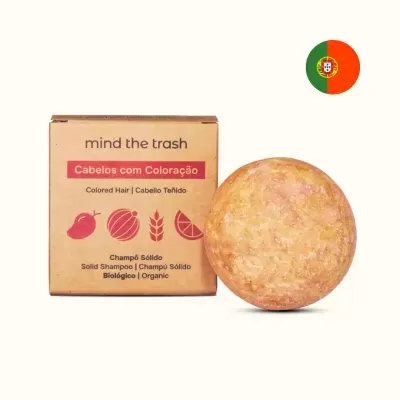 Champô sólido para cabelos com coloração com embalagem castanha e barra redonda alaranjada.