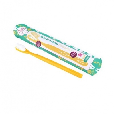 Escova de dentes amarela ecológica em embalagem sustentável.