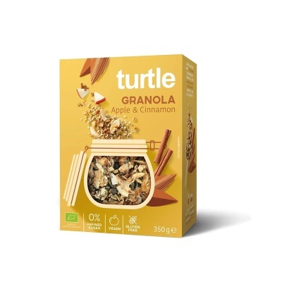 Caixa amarela de granola Turtle Maçã e Canela com imagem de frasco de granola e paus de canela