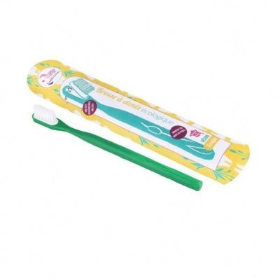 Escova de dentes ecológica verde com embalagem amarela decorada