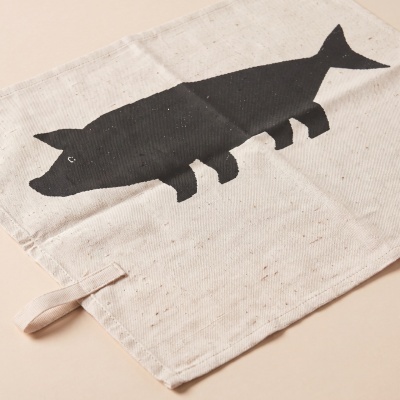 Beige fabric item with black pig silhouette print and loop on one corner