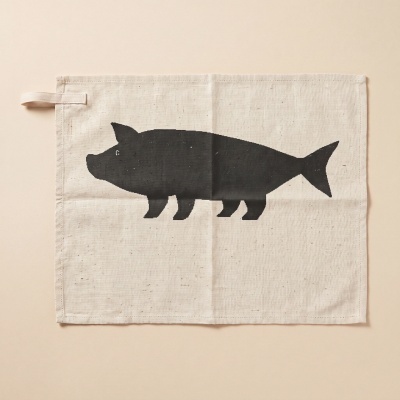 Beige canvas with black pig silhouette with fish tail and hanging loop