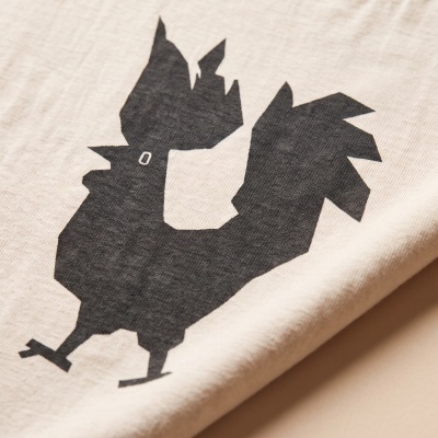 Beige fabric with black printed chicken design and white eye detail