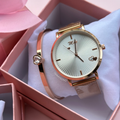 Relógio dourado com pulseira metálica e pulseira dourada com coração em caixa rosa