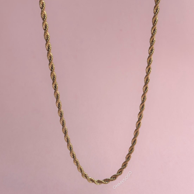 Colar dourado com corrente torcida pendurado em fundo cor-de-rosa