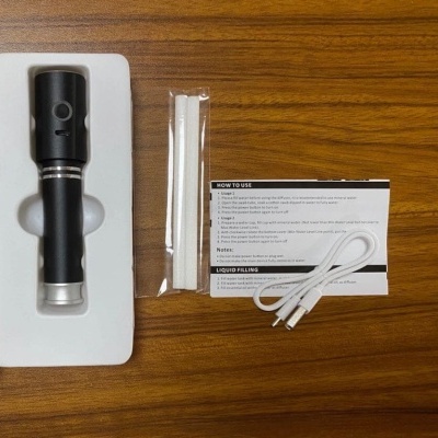 Conjunto para vaporizador com corpo principal preto e prateado, dois filtros brancos, cabo USB branco e cartão de instruções.