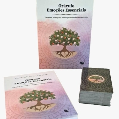 Oráculo Emoções Essenciais com caixa, livro e baralho de cartas com imagem de árvore em fundo rosa lilás.