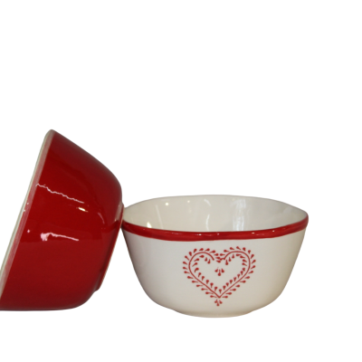 Duas tigelas de cerâmica, uma vermelha e outra branca com decoração de coração vermelho