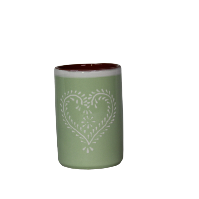 Copo de cerâmica verde claro decorado com padrão branco em forma de coração