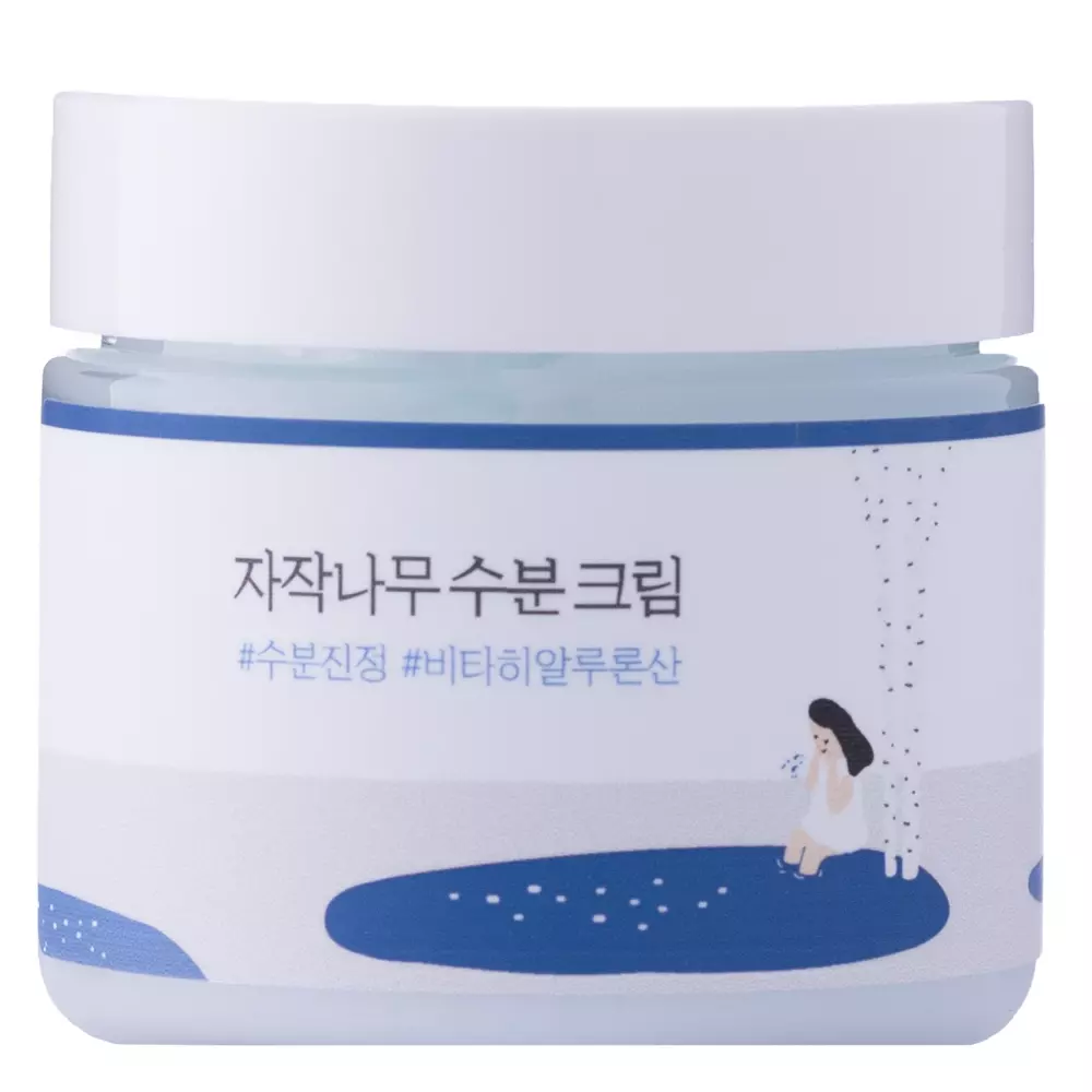Frasco de creme hidratante com tampa branca e rótulo branco e azul com texto em coreano e ilustração