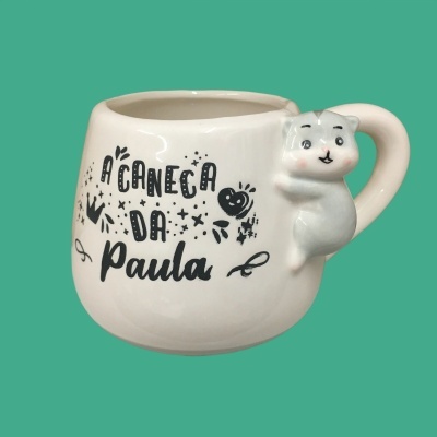 Caneca branca de cerâmica com texto e gato 3D agarrado à pega