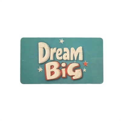 Placa decorativa azul com texto 'Dream Big' e estrelas.