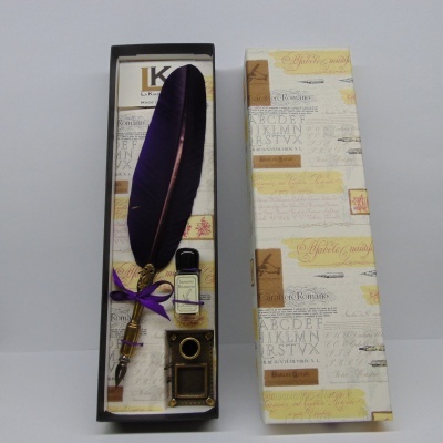 Conjunto de escrita com pena roxa e tinteiro numa caixa decorada