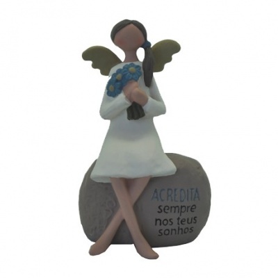 Estátua de anjo sentada com vestido branco e asas verdes