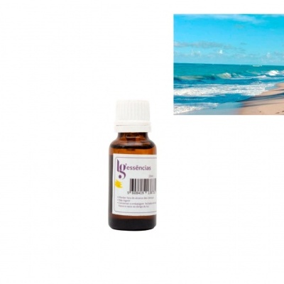 Frasco pequeno de essência de vidro castanho com rótulo num fundo branco e imagem de praia e mar ao lado