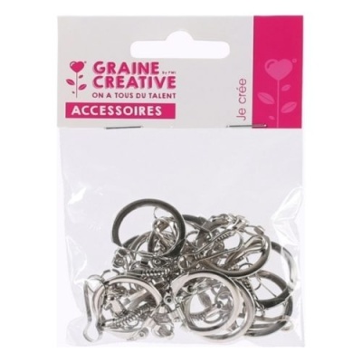 Pacote de acessórios metálicos prateados para criação em embalagem transparente com cartão branco e rosa.