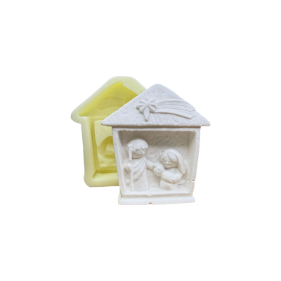 Molde de silicone amarelo com figura de gesso de presépio natalício branco