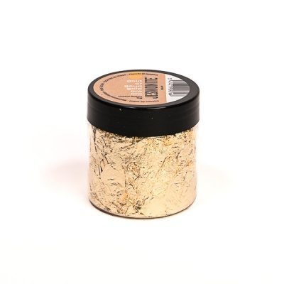 Frasco pequeno com folha dourada e tampa preta com etiqueta no topo