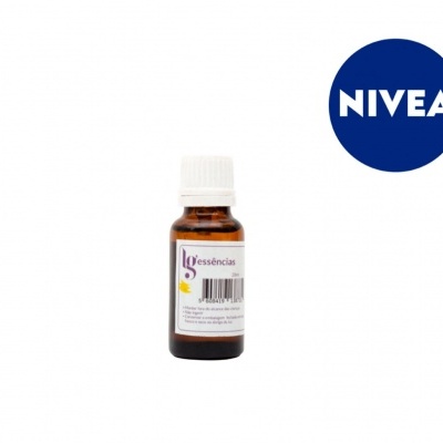 Garrafa pequena de vidro castanho com tampa branca e etiqueta Essência