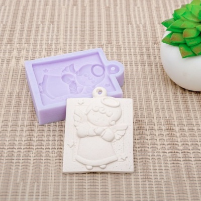 Forma de silicone lilás e peça de gesso com desenho de menina, vaso branco com planta
