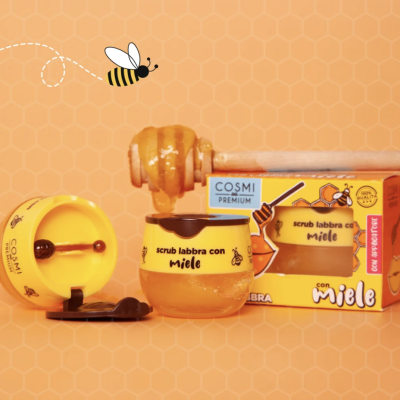 Esfoliante labial com mel COSMI PREMIUM em frasco de vidro amarelo com embalagem amarela e colher aplicadora