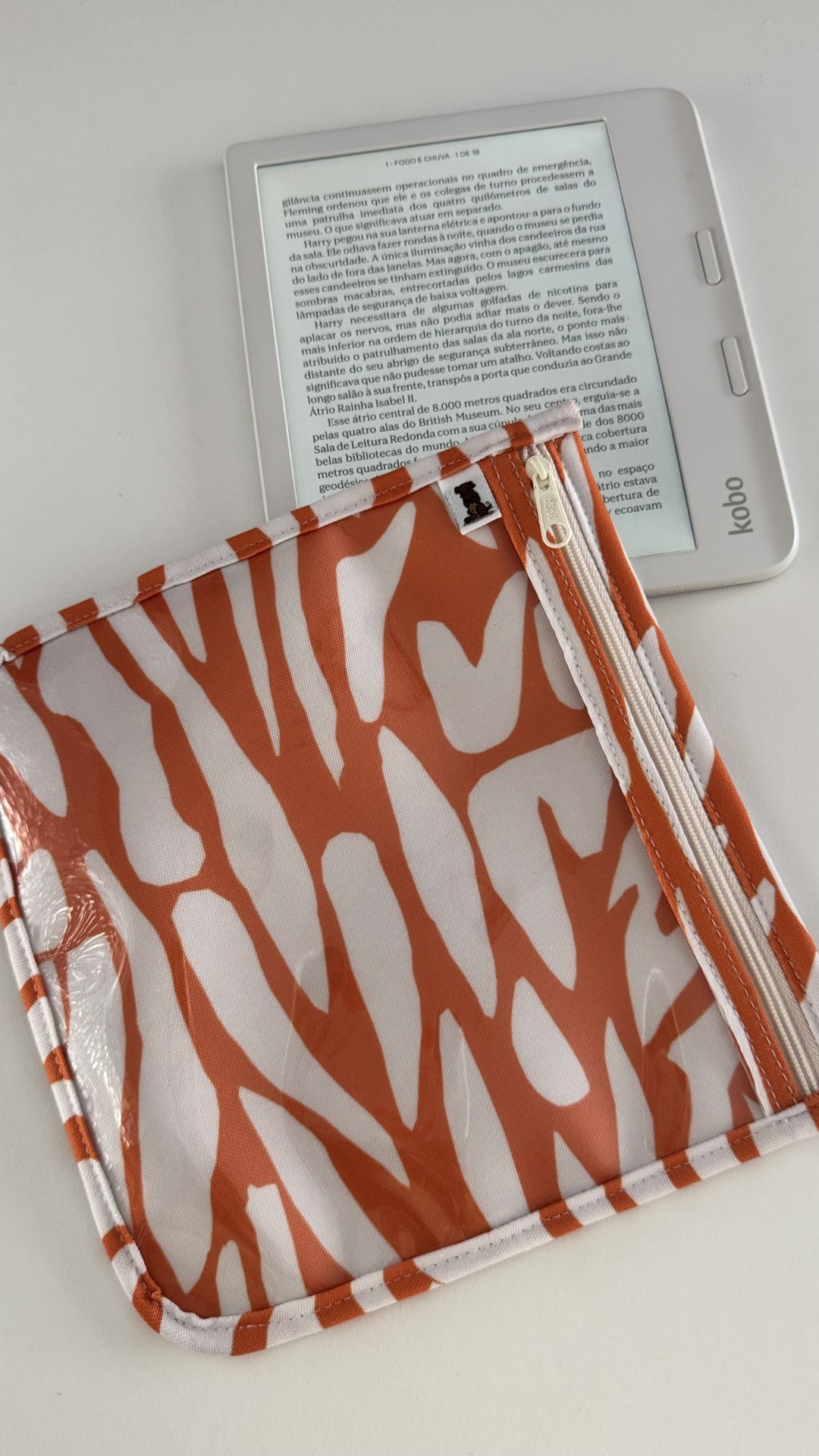 Capa laranja e branca para e-reader junto a um e-reader Kobo branco