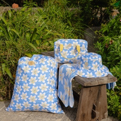 Conjunto de mochila, necessaire, chapéu e toalha com padrão floral azul